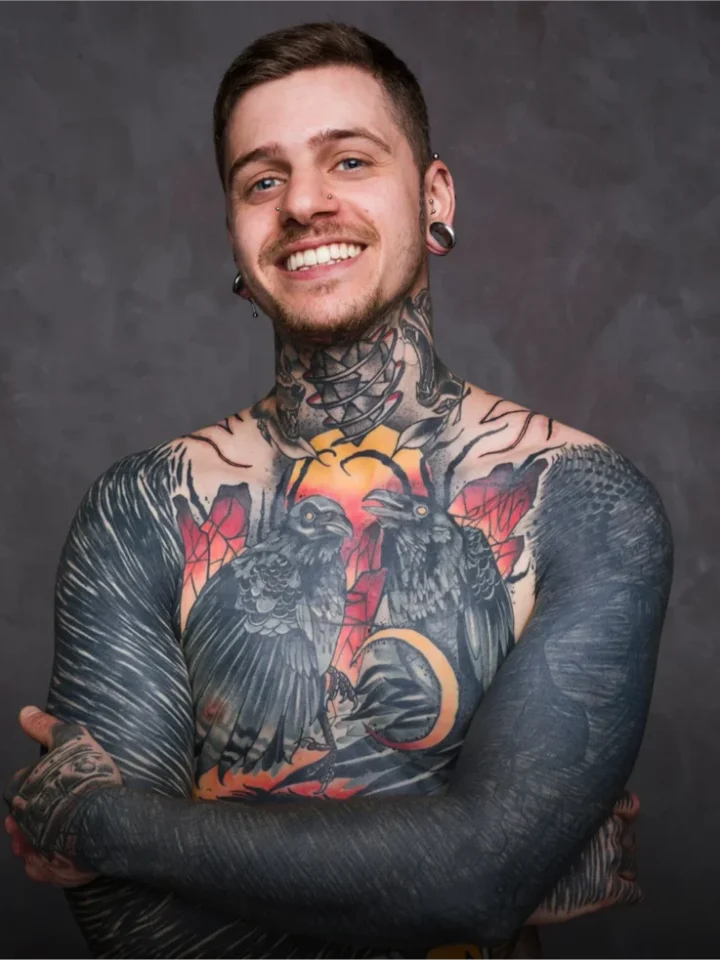 Man with full colour realism chest and sleeve tattoos