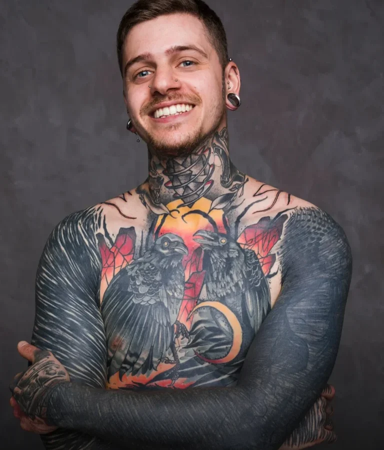 Man with full colour realism chest and sleeve tattoos