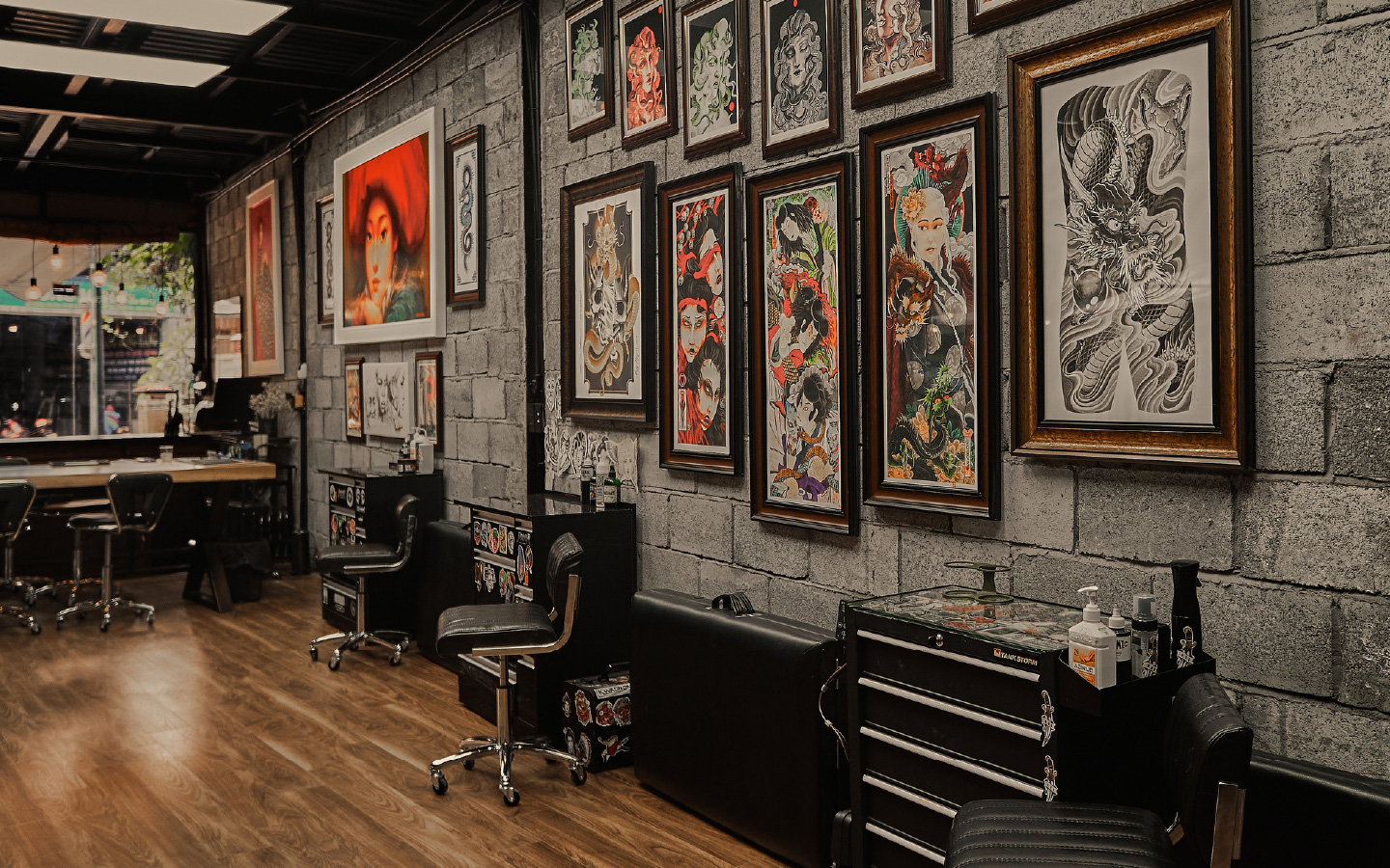 Tattoo studio interior with framed flash designs along the wall