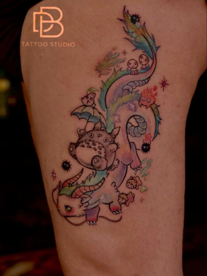 Pastel colour phoenix tattoo trailing across a thigh
