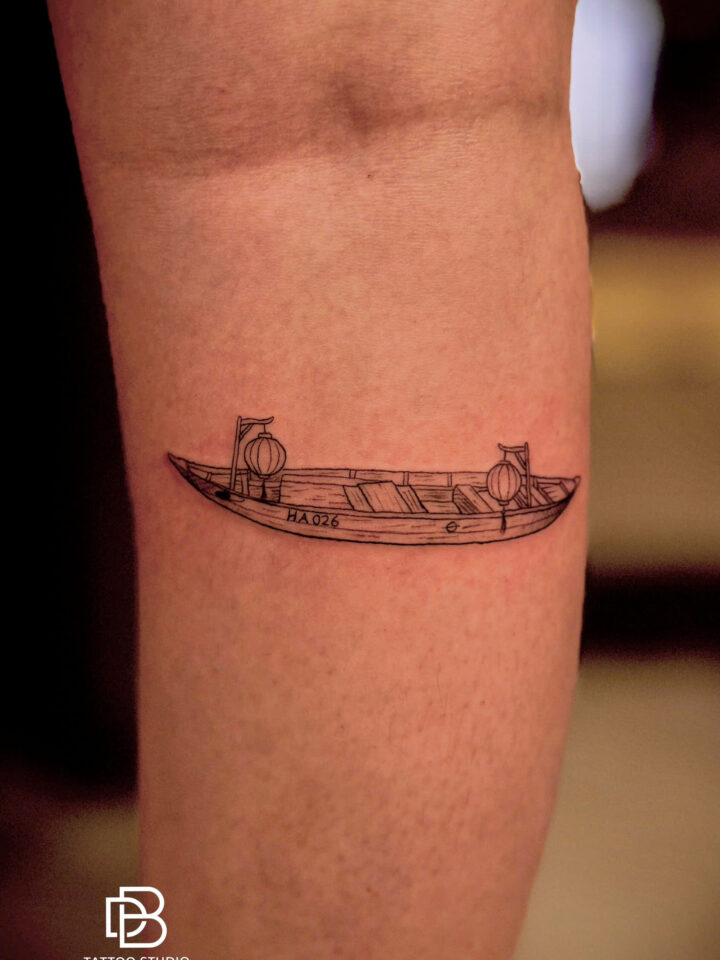 Small Vietnamese rowing boat tattooed on a forearm