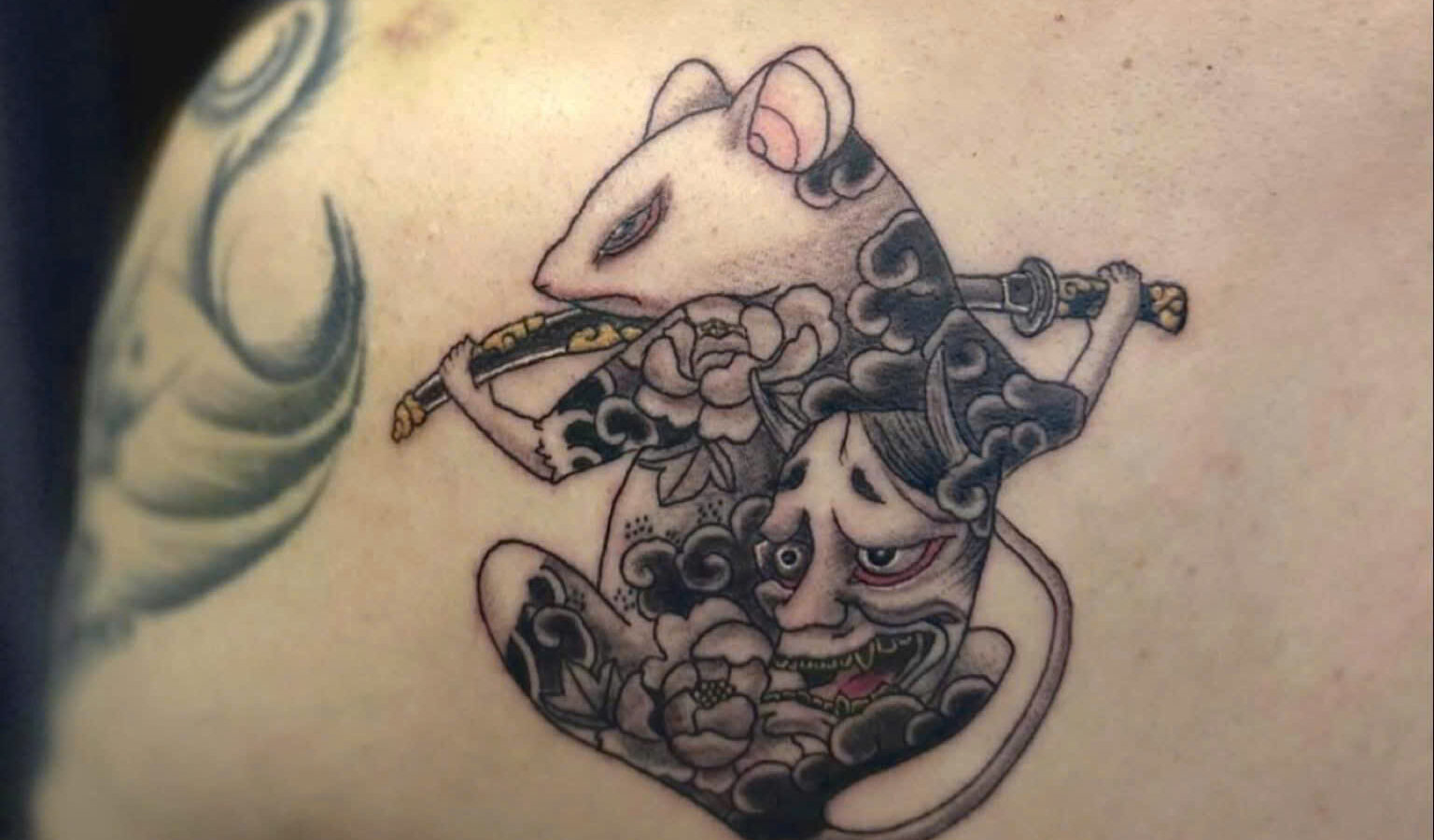 Blackwork rat warrior tattooed on a shoulder blade