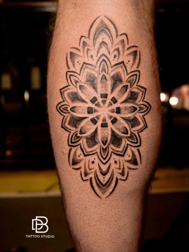 Dotwork mandala tattooed on a calf