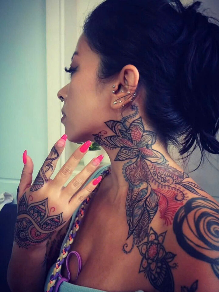 Ornamental mandala tattoo covering the neck, shoulder and hand