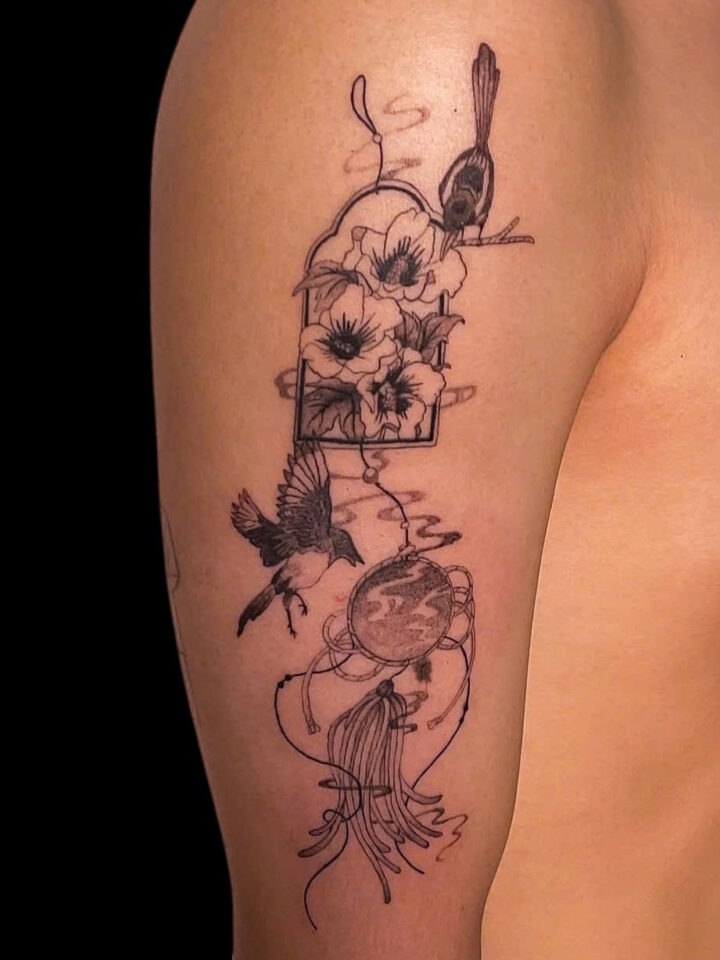 Fine line poppies, a swallow and a pocket watch tattooed on an upper arm