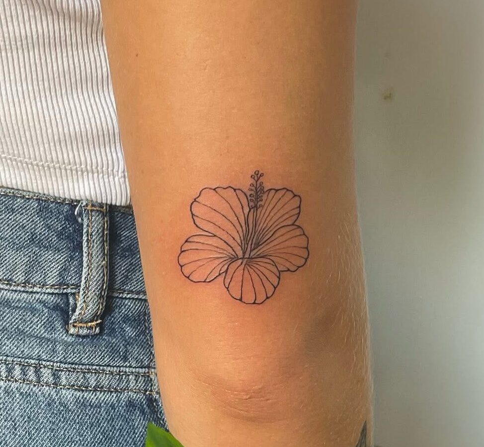 Small hibiscus outline tattoo on the back of an arm