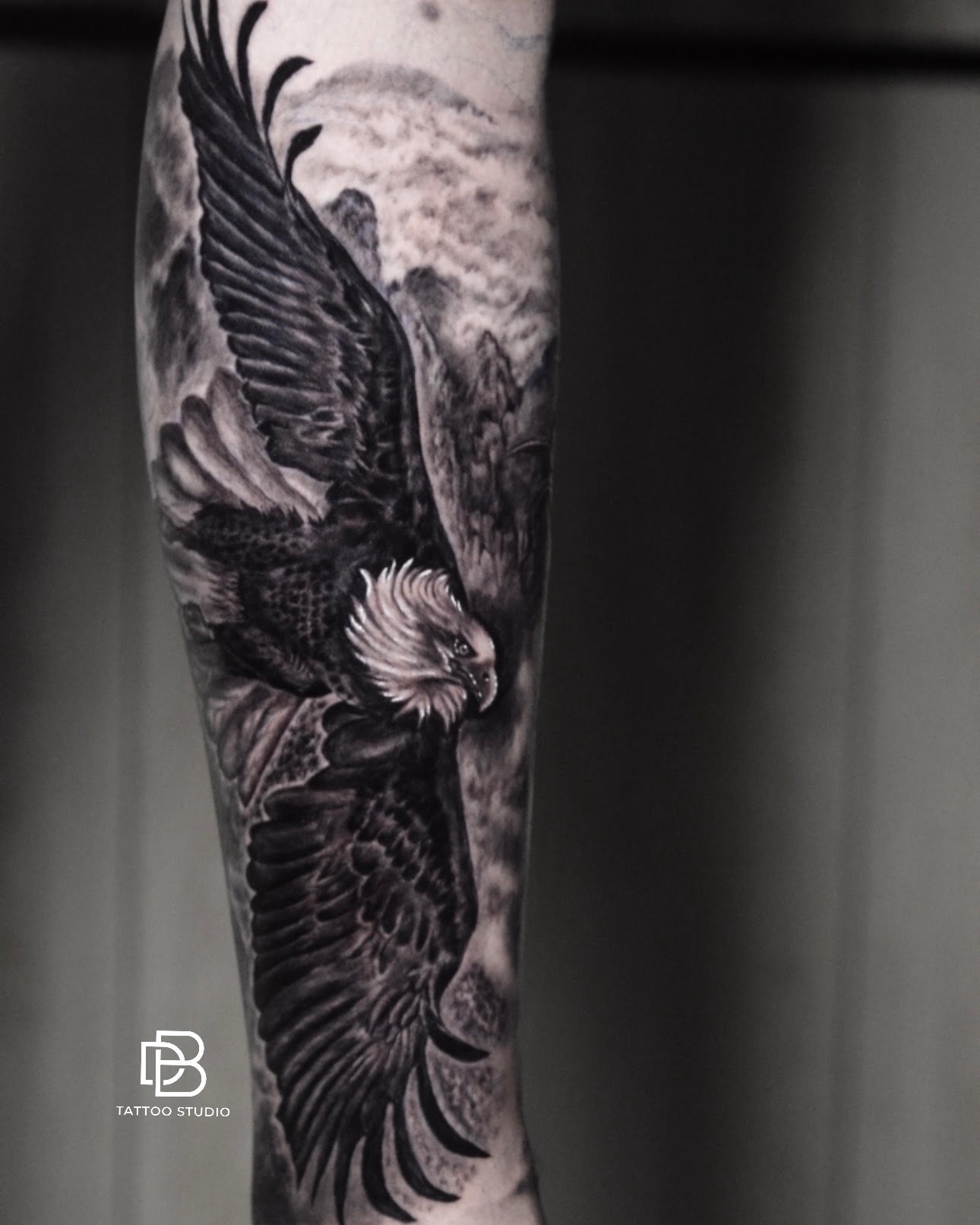 Realistic eagle tattoo in Hoi An, black and grey forearm tattoo by DanBam Tattoo Studio. Detailed bald eagle tattoo symbolizing strength and freedom.