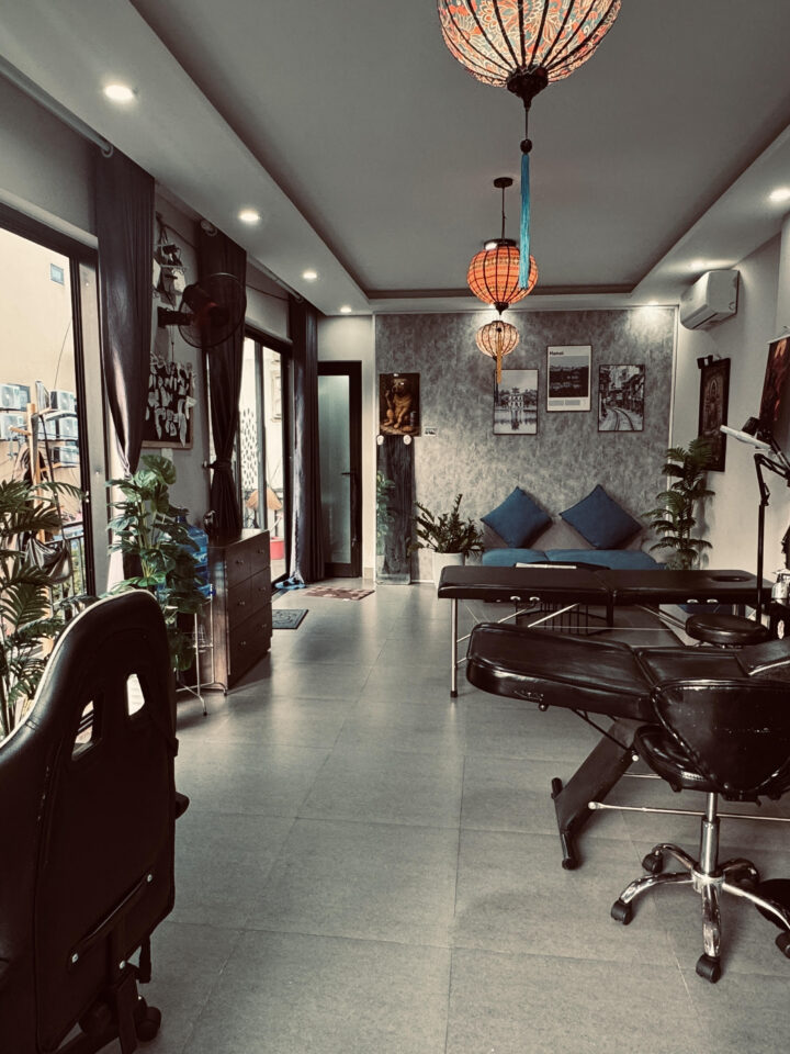 Tattoo room at DanBam Tattoo Hoi An with two beds and a paper lantern