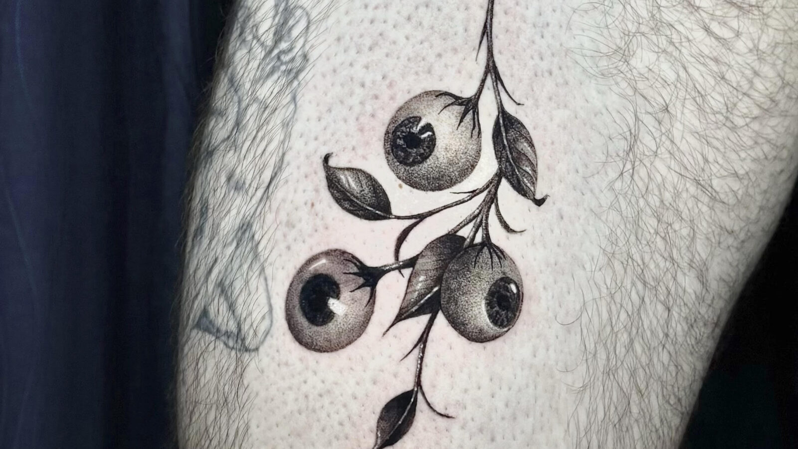 Black and grey rose tattoo on forearm by DanBam Tattoo in Hoi An, Vietnam
