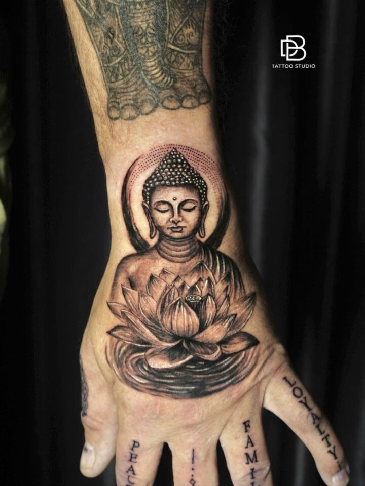 Realism tattoo of a Buddha seated above a lotus on the back of a hand